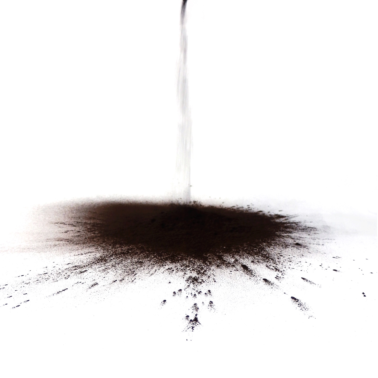 Dark AHE powder falling onto a pale surface